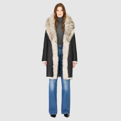 The JOY Jacket is a heritage-inspired reversible outerwear piece crafted in yingyang Toscana shearling. Designed to flip seamlessly from plush oversized teddy to sleek suede, it offers versatile styling for both après-ski sophistication and everyday winter elegance. With a drop shoulder, large notch collar, and oversized silhouette, JOY combines comfort with modern edge. Functional slash side pockets on the teddy side and single welt pockets on the nappa side, along with a front button closure.