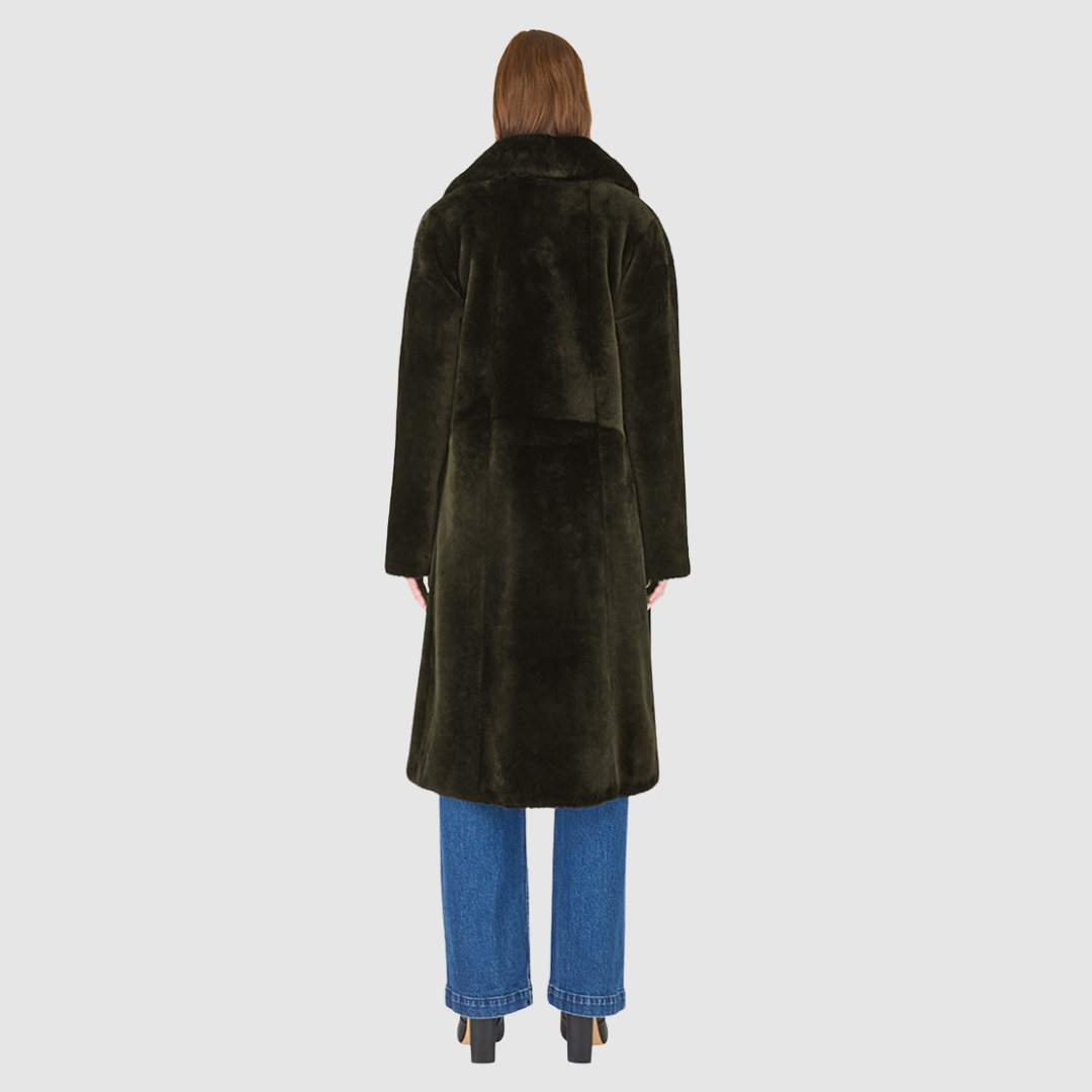 The PRADO Coat is a luxury vintage-inspired wool teddy coat crafted from khaki ironed wool for a textured, modern finish. Designed with a relaxed dropped shoulder and tie belt at the waist, it combines effortless comfort with a flattering, cinched silhouette. A notch collar, large side patch pockets, and front button closure complete this statement wool teddy coat, perfect for elevated cold-weather styling.