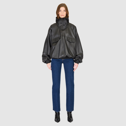 The Realm Black Leather Anorak Jacket is a modern interpretation of the classic anorak, elevated in luxury leather for a bold yet versatile statement. Designed with an oversized silhouette, it features a structured funnel neck collar and a concealed half-zip placket with gunmetal snap closures. Voluminous balloon sleeves and a cinched hem bring sculptural dimension, while functional flap pockets add everyday utility. A fusion of designer craftsmanship and contemporary outerwear design