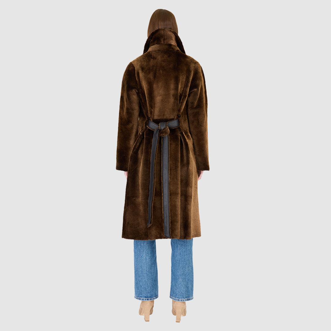 The ZIRA Coat is a heritage-inspired vintage reversible shearling jacket crafted in macassar nappa and iron wool. Designed to flip effortlessly from sleek nappa to plush iron wool teddy, it delivers versatile styling for both après-ski sophistication and everyday cold-weather elegance. Featuring a relaxed dropped shoulder, notch collar, and 3-button closure, ZIRA combines modern tailoring with timeless texture. Practical zip pockets on the nappa side and patch pockets on the teddy side, along with tie belt