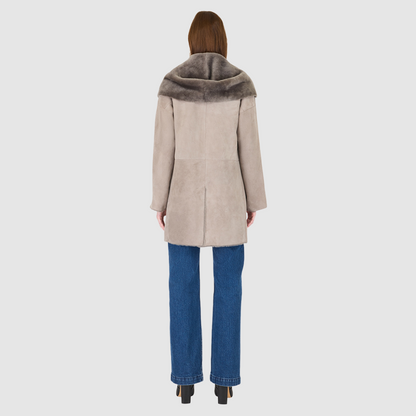 The BAYLIE Reversible Shearling Jacket is a statement in modern versatility and effortless luxury. Crafted in fog suede that reverses to plush ironed wool, it offers two distinct looks in one oversized silhouette. An oversized hood that converts to a dramatic shawl collar adds functional elegance, while raw-edge finishing underscores its contemporary appeal. Designed with drop shoulders and pull-through pockets, BAYLIE moves seamlessly between heritage inspiration and après-ski sophistication.