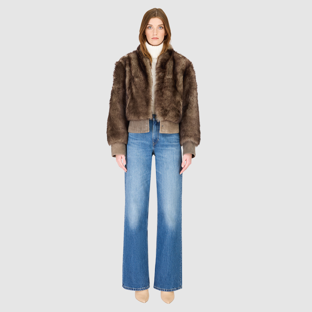 Elevate your outerwear collection with our Women's Cropped Toscana Wool Bomber. Designed for bold style and warmth, this luxe jacket features oversized shoulders and a sleek stand collar for a modern edge. Fully lined for comfort, it offers practical slash side pockets and a secure hook closure. Perfect for chilly days, this statement bomber blends fashion and function, making it an essential addition to any winter wardrobe.