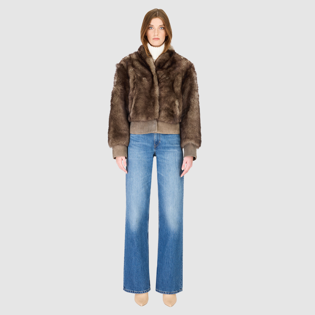 Elevate your outerwear collection with our Women's Cropped Toscana Wool Bomber. Designed for bold style and warmth, this luxe jacket features oversized shoulders and a sleek stand collar for a modern edge. Fully lined for comfort, it offers practical slash side pockets and a secure hook closure. Perfect for chilly days, this statement bomber blends fashion and function, making it an essential addition to any winter wardrobe.