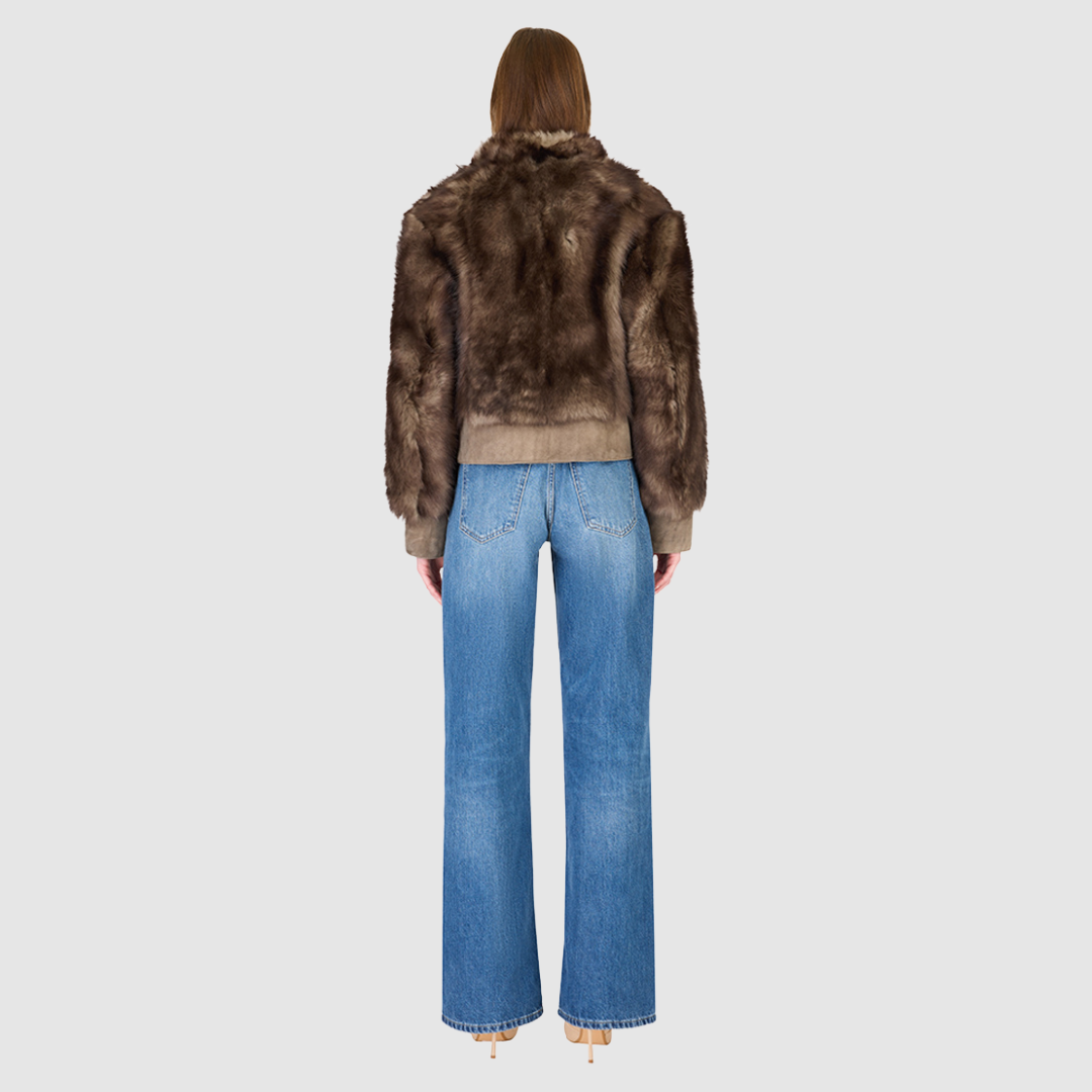 Elevate your outerwear collection with our Women's Cropped Toscana Wool Bomber. Designed for bold style and warmth, this luxe jacket features oversized shoulders and a sleek stand collar for a modern edge. Fully lined for comfort, it offers practical slash side pockets and a secure hook closure. Perfect for chilly days, this statement bomber blends fashion and function, making it an essential addition to any winter wardrobe.