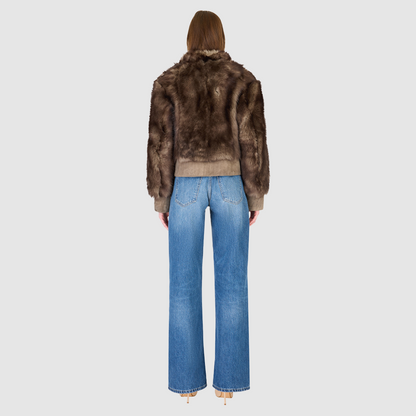 Elevate your outerwear collection with our Women's Cropped Toscana Wool Bomber. Designed for bold style and warmth, this luxe jacket features oversized shoulders and a sleek stand collar for a modern edge. Fully lined for comfort, it offers practical slash side pockets and a secure hook closure. Perfect for chilly days, this statement bomber blends fashion and function, making it an essential addition to any winter wardrobe.