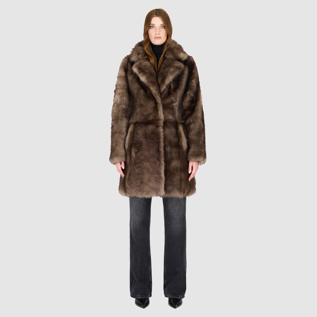 The CLOUD Jacket is a cozy, elevated outerwear essential crafted in Taupe Badger Toscana wool-out mouton teddy. Designed with a regular shoulder and fitted torso, it provides a flattering silhouette while maintaining comfort across the shoulders. Functional slash side pockets and interior zip pockets keep essentials secure, while a front snap closure completes the clean, versatile design. CLOUD blends plush texture with modern tailoring for effortless cold weather style.