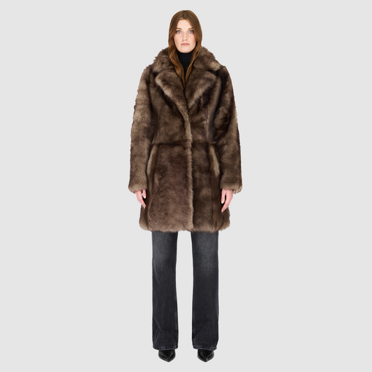 The CLOUD Jacket is a cozy, elevated outerwear essential crafted in Taupe Badger Toscana wool-out mouton teddy. Designed with a regular shoulder and fitted torso, it provides a flattering silhouette while maintaining comfort across the shoulders. Functional slash side pockets and interior zip pockets keep essentials secure, while a front snap closure completes the clean, versatile design. CLOUD blends plush texture with modern tailoring for effortless cold weather style.