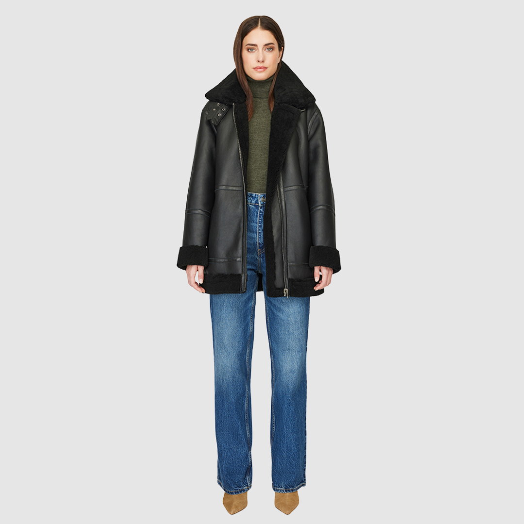 The DEZ Jacket is a heritage-inspired reversible medium-length shearling moto crafted in jet nappa&nbsp;leather with plush curly wool teddy on the reverse. Designed for a relaxed silhouette with drop shoulders, curly wool collar and trims, and a straight fit, DEZ combines modern edge with timeless texture. Functional patch pockets on both nappa and wool sides and a front zip closure make this jacket as practical as it is versatile, perfect for après-ski layering or elevated city styling.