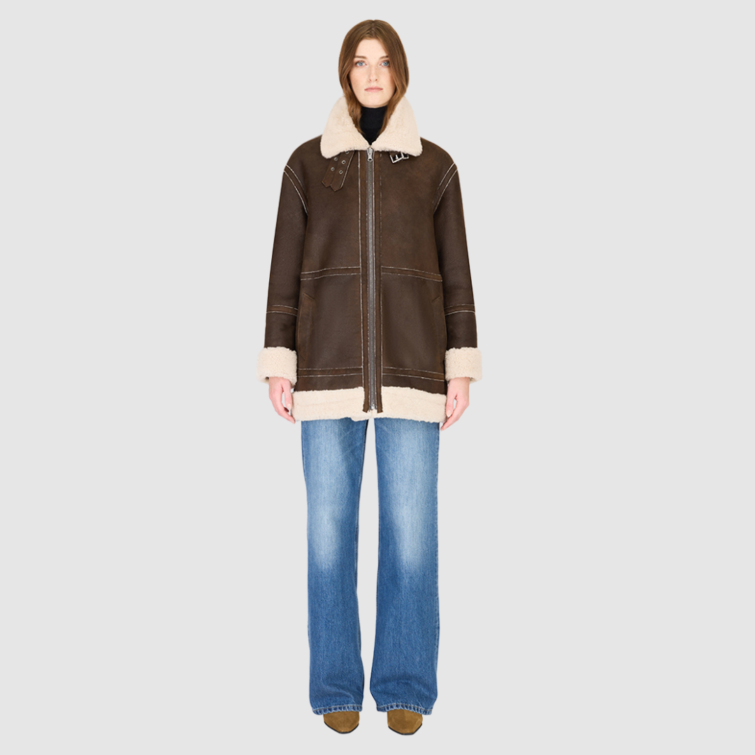 The DEZ Jacket is a heritage-inspired reversible medium-length shearling moto crafted in arabica suede&nbsp;leather with plush curly wool teddy on the reverse. Designed for a relaxed silhouette with drop shoulders, curly wool collar and trims, and a straight fit, DEZ combines modern edge with timeless texture. Functional patch pockets on both suede and wool sides and a front zip closure make this jacket as practical as it is versatile, perfect for après-ski layering or elevated city styling.