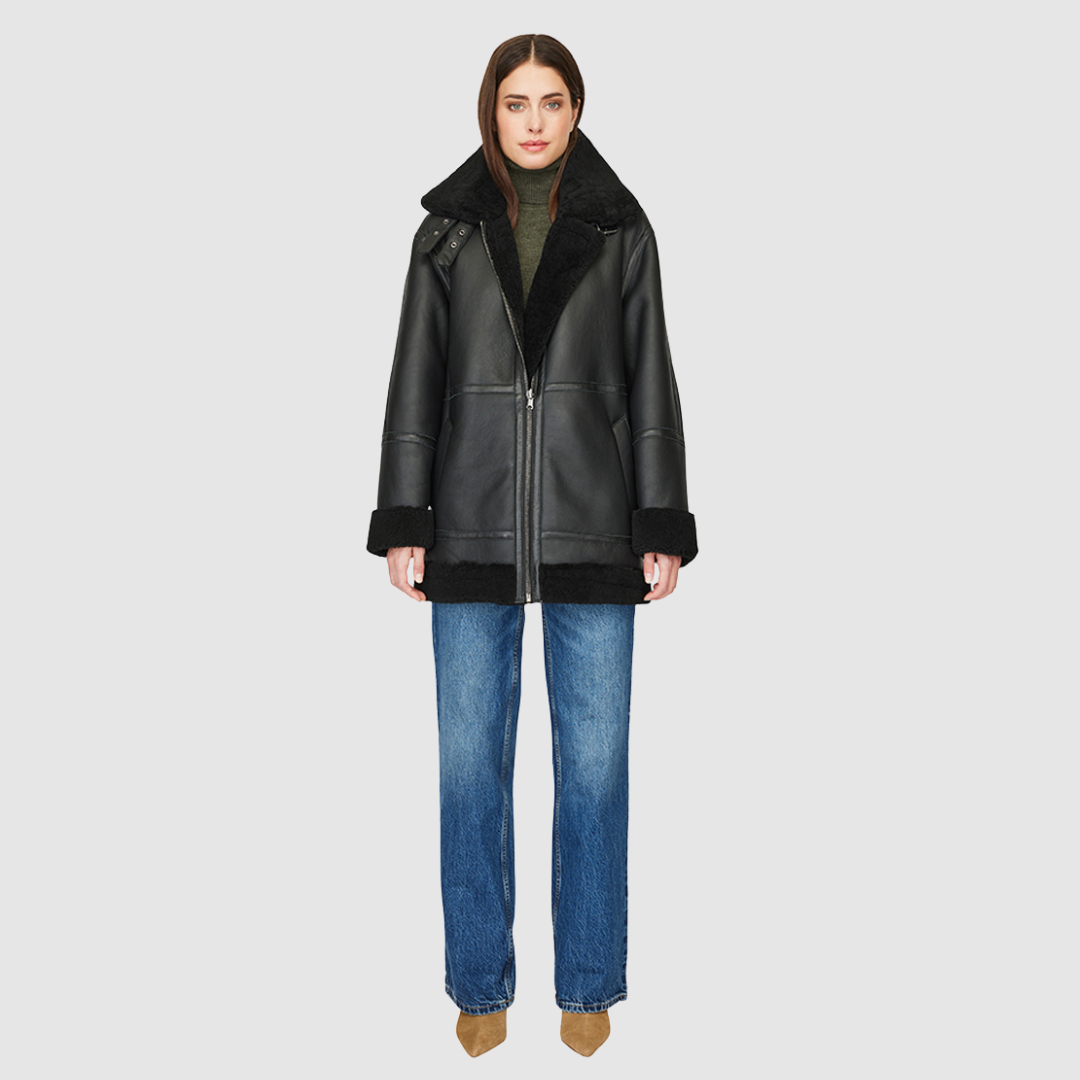 The DEZ Jacket is a heritage-inspired reversible medium-length shearling moto crafted in jet nappa&nbsp;leather with plush curly wool teddy on the reverse. Designed for a relaxed silhouette with drop shoulders, curly wool collar and trims, and a straight fit, DEZ combines modern edge with timeless texture. Functional patch pockets on both nappa and wool sides and a front zip closure make this jacket as practical as it is versatile, perfect for après-ski layering or elevated city styling.