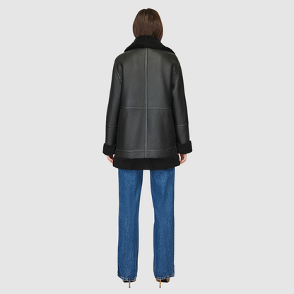The DEZ Jacket is a heritage-inspired reversible medium-length shearling moto crafted in jet nappa&nbsp;leather with plush curly wool teddy on the reverse. Designed for a relaxed silhouette with drop shoulders, curly wool collar and trims, and a straight fit, DEZ combines modern edge with timeless texture. Functional patch pockets on both nappa and wool sides and a front zip closure make this jacket as practical as it is versatile, perfect for après-ski layering or elevated city styling.