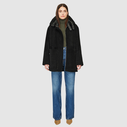 The DEZ Jacket is a heritage-inspired reversible medium-length shearling moto crafted in jet nappa&nbsp;leather with plush curly wool teddy on the reverse. Designed for a relaxed silhouette with drop shoulders, curly wool collar and trims, and a straight fit, DEZ combines modern edge with timeless texture. Functional patch pockets on both nappa and wool sides and a front zip closure make this jacket as practical as it is versatile, perfect for après-ski layering or elevated city styling.