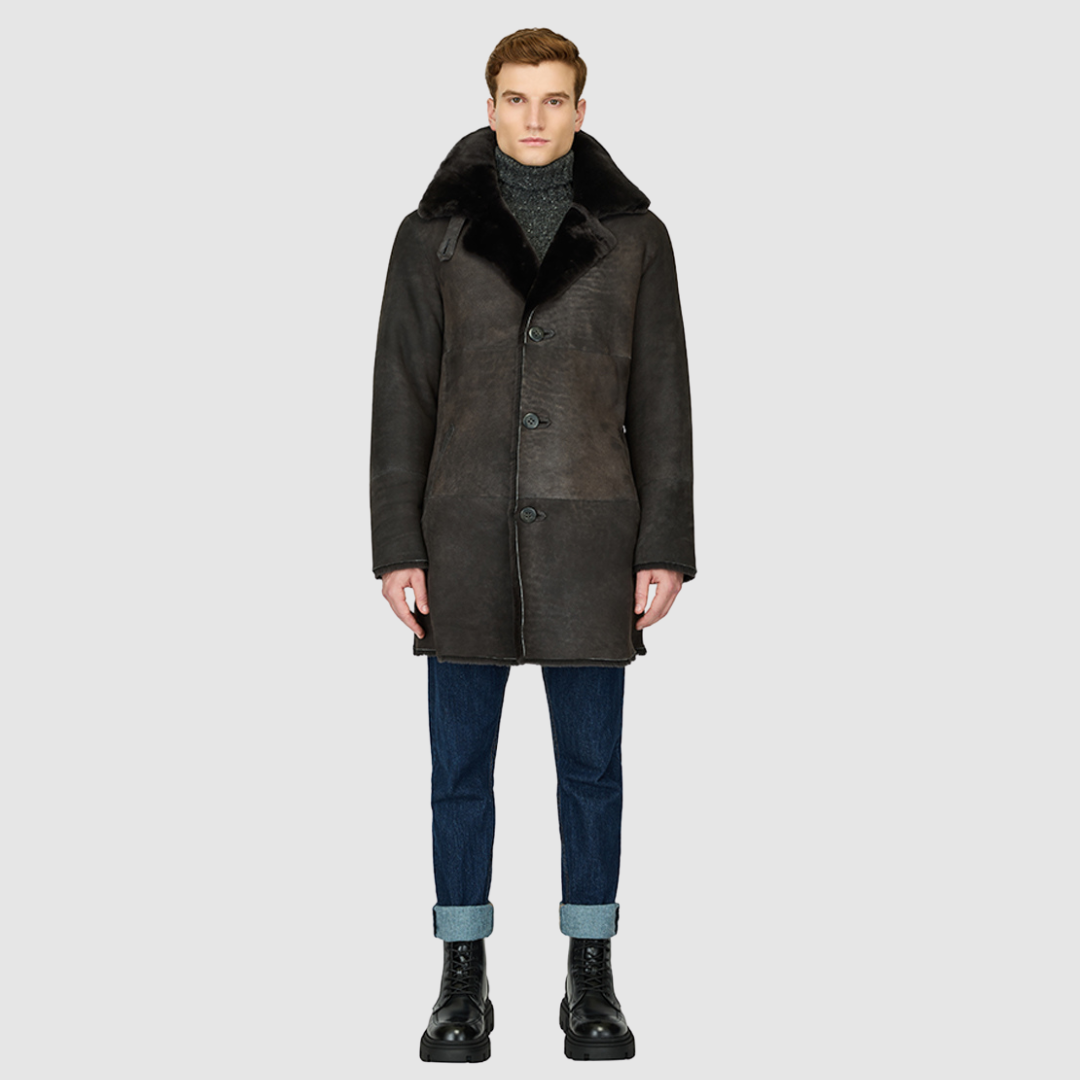 The Edson Black Vintage Reversible Shearling Jacket is a mid-length men’s coat engineered for winter warmth and versatile styling. Crafted from luxe suede with a plush ironed wool teddy reverse, it delivers two distinct silhouettes: structured and tailored when suede-out, or relaxed and oversized when wool-out. Designed with a spread collar, raw edge detailing, and functional dual pockets, this jacket provides effortless layering and superior cold-weather protection. Edson balances timeless shearling crafts