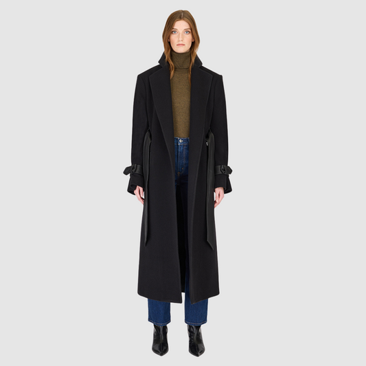 The EVERLY – Black coat is a statement outerwear piece crafted from a premium Italian wool-cashmere blend. This structured coat features a notch collar, leather tie belt at the waist, and refined leather accents at the cuffs, storm back, and welt pockets. A back vent ensures comfort and movement, while the tailored silhouette delivers timeless sophistication. Perfect as a luxury winter coat or everyday wool jacket, the EVERLY defines modern elegance with edge.