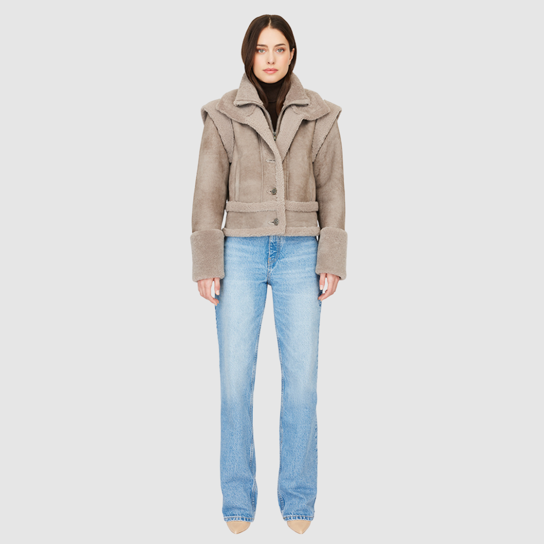The GRAVITY Jacket is a heritage-inspired cropped shearling moto crafted in smoked quartz nappa leather with&nbsp;&nbsp;wool collar, shoulders, and trims for luxe texture. Its double curly wool collar and convertible design with removable zip sleeves allow it to transform into a vest, offering versatile layering for après-ski adventures or urban winter styling. Functional interior zip pocket, exterior single welt side pockets, and front zip with button closure complete this dynamic, modern shearling moto.