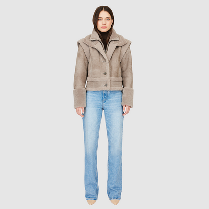 The GRAVITY Jacket is a heritage-inspired cropped shearling moto crafted in smoked quartz nappa leather with&nbsp;&nbsp;wool collar, shoulders, and trims for luxe texture. Its double curly wool collar and convertible design with removable zip sleeves allow it to transform into a vest, offering versatile layering for après-ski adventures or urban winter styling. Functional interior zip pocket, exterior single welt side pockets, and front zip with button closure complete this dynamic, modern shearling moto.