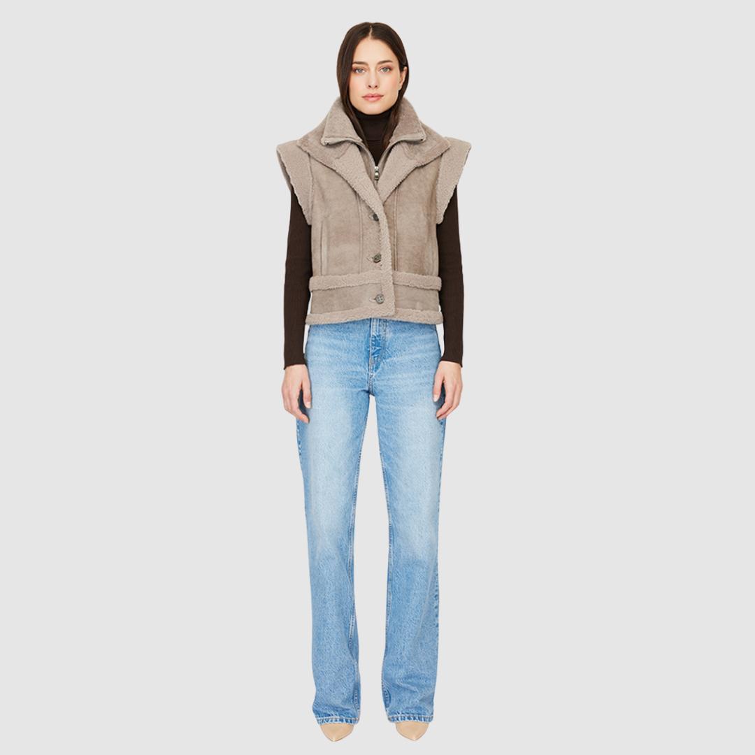 The GRAVITY Jacket is a heritage-inspired cropped shearling moto crafted in smoked quartz nappa leather with&nbsp;&nbsp;wool collar, shoulders, and trims for luxe texture. Its double curly wool collar and convertible design with removable zip sleeves allow it to transform into a vest, offering versatile layering for après-ski adventures or urban winter styling. Functional interior zip pocket, exterior single welt side pockets, and front zip with button closure complete this dynamic, modern shearling moto.