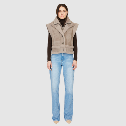 The GRAVITY Jacket is a heritage-inspired cropped shearling moto crafted in smoked quartz nappa leather with&nbsp;&nbsp;wool collar, shoulders, and trims for luxe texture. Its double curly wool collar and convertible design with removable zip sleeves allow it to transform into a vest, offering versatile layering for après-ski adventures or urban winter styling. Functional interior zip pocket, exterior single welt side pockets, and front zip with button closure complete this dynamic, modern shearling moto.