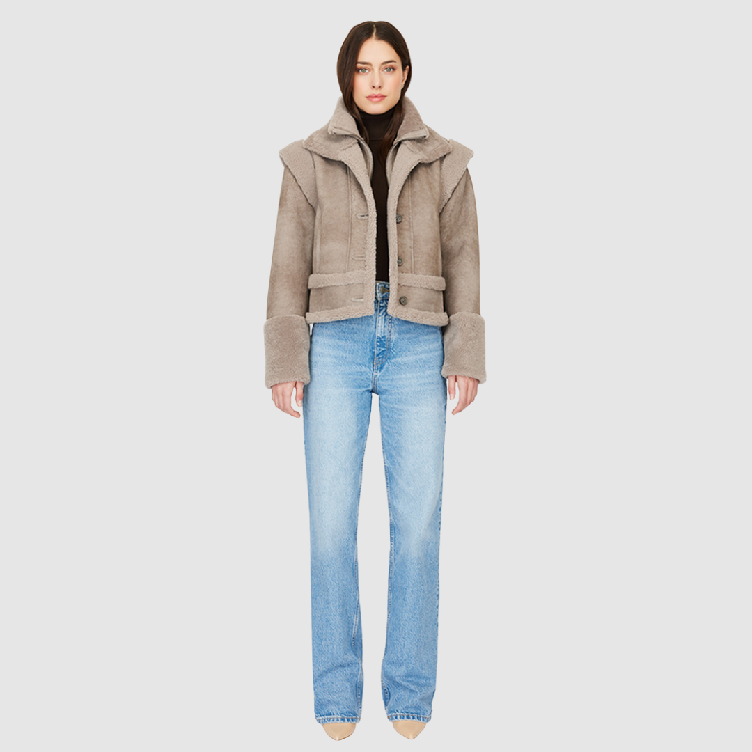 The GRAVITY Jacket is a heritage-inspired cropped shearling moto crafted in smoked quartz nappa leather with&nbsp;&nbsp;wool collar, shoulders, and trims for luxe texture. Its double curly wool collar and convertible design with removable zip sleeves allow it to transform into a vest, offering versatile layering for après-ski adventures or urban winter styling. Functional interior zip pocket, exterior single welt side pockets, and front zip with button closure complete this dynamic, modern shearling moto.