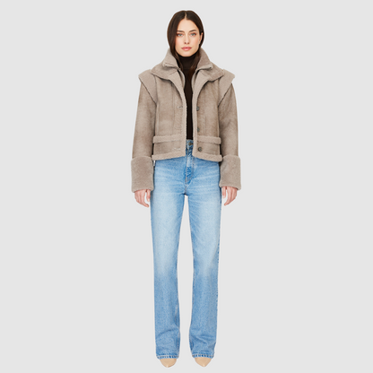 The GRAVITY Jacket is a heritage-inspired cropped shearling moto crafted in smoked quartz nappa leather with&nbsp;&nbsp;wool collar, shoulders, and trims for luxe texture. Its double curly wool collar and convertible design with removable zip sleeves allow it to transform into a vest, offering versatile layering for après-ski adventures or urban winter styling. Functional interior zip pocket, exterior single welt side pockets, and front zip with button closure complete this dynamic, modern shearling moto.