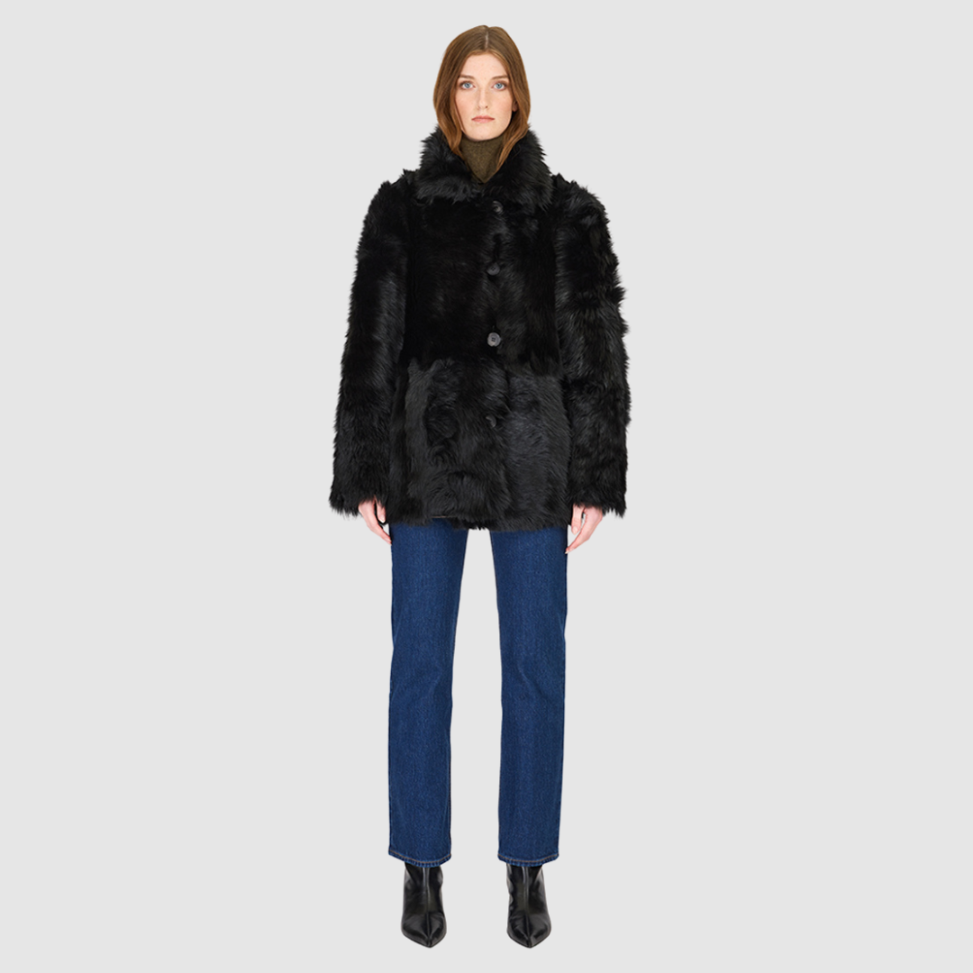 The MILKY WAY Jacket is a versatile statement piece crafted in Jet Toscana shearling, designed as a reversible teddy that flips to a nappa skin-out jacket. It offers a relaxed fit when worn wool-out and a regular fit when worn skin-out. A spread collar adds structure, while slash side pockets on the teddy side and patch side pockets on the nappa side provide functionality. Finished with a front button closure, MILKY WAY combines plush texture with sleek nappa styling for modern cold-weather versatility.