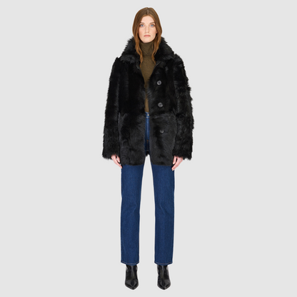 The MILKY WAY Jacket is a versatile statement piece crafted in Jet Toscana shearling, designed as a reversible teddy that flips to a nappa skin-out jacket. It offers a relaxed fit when worn wool-out and a regular fit when worn skin-out. A spread collar adds structure, while slash side pockets on the teddy side and patch side pockets on the nappa side provide functionality. Finished with a front button closure, MILKY WAY combines plush texture with sleek nappa styling for modern cold-weather versatility.