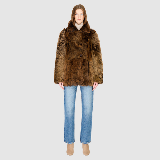 The MILKY WAY Jacket is a versatile statement piece crafted in macassar nappa shearling, designed as a reversible teddy that flips to a nappa skin-out jacket. It offers a relaxed fit when worn wool-out and a regular fit when worn skin-out. A spread collar adds structure, while slash side pockets on the teddy side and patch side pockets on the nappa side provide functionality. Finished with a front button closure, MILKY WAY combines plush texture with sleek nappa styling for modern cold-weather versatility.