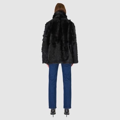 The MILKY WAY Jacket is a versatile statement piece crafted in Jet Toscana shearling, designed as a reversible teddy that flips to a nappa skin-out jacket. It offers a relaxed fit when worn wool-out and a regular fit when worn skin-out. A spread collar adds structure, while slash side pockets on the teddy side and patch side pockets on the nappa side provide functionality. Finished with a front button closure, MILKY WAY combines plush texture with sleek nappa styling for modern cold-weather versatility.