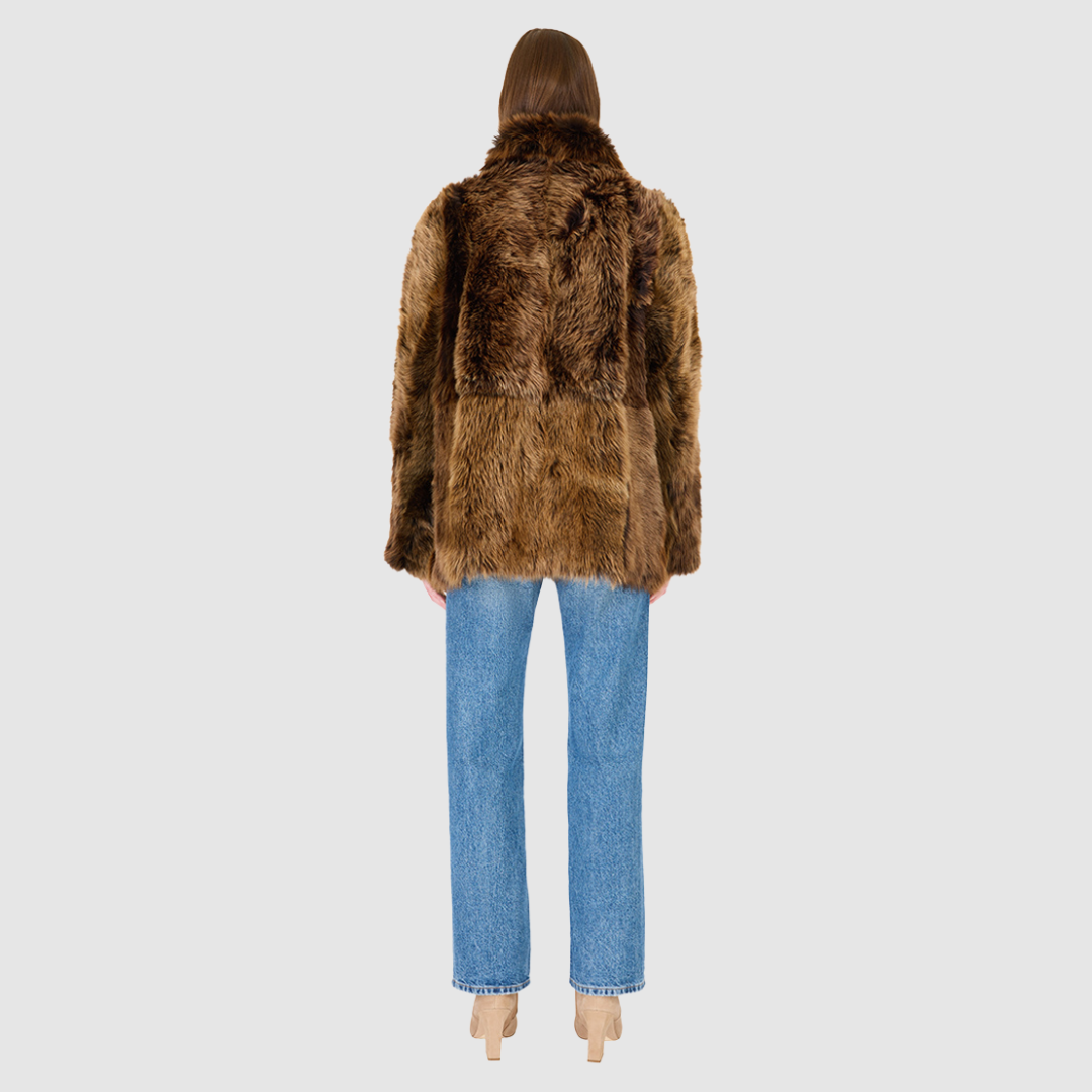 The MILKY WAY Jacket is a versatile statement piece crafted in macassar nappa shearling, designed as a reversible teddy that flips to a nappa skin-out jacket. It offers a relaxed fit when worn wool-out and a regular fit when worn skin-out. A spread collar adds structure, while slash side pockets on the teddy side and patch side pockets on the nappa side provide functionality. Finished with a front button closure, MILKY WAY combines plush texture with sleek nappa styling for modern cold-weather versatility.