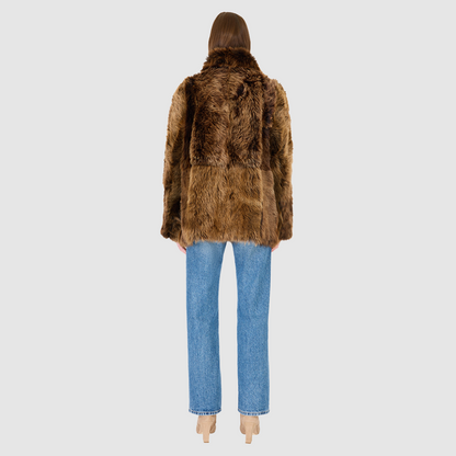 The MILKY WAY Jacket is a versatile statement piece crafted in macassar nappa shearling, designed as a reversible teddy that flips to a nappa skin-out jacket. It offers a relaxed fit when worn wool-out and a regular fit when worn skin-out. A spread collar adds structure, while slash side pockets on the teddy side and patch side pockets on the nappa side provide functionality. Finished with a front button closure, MILKY WAY combines plush texture with sleek nappa styling for modern cold-weather versatility.
