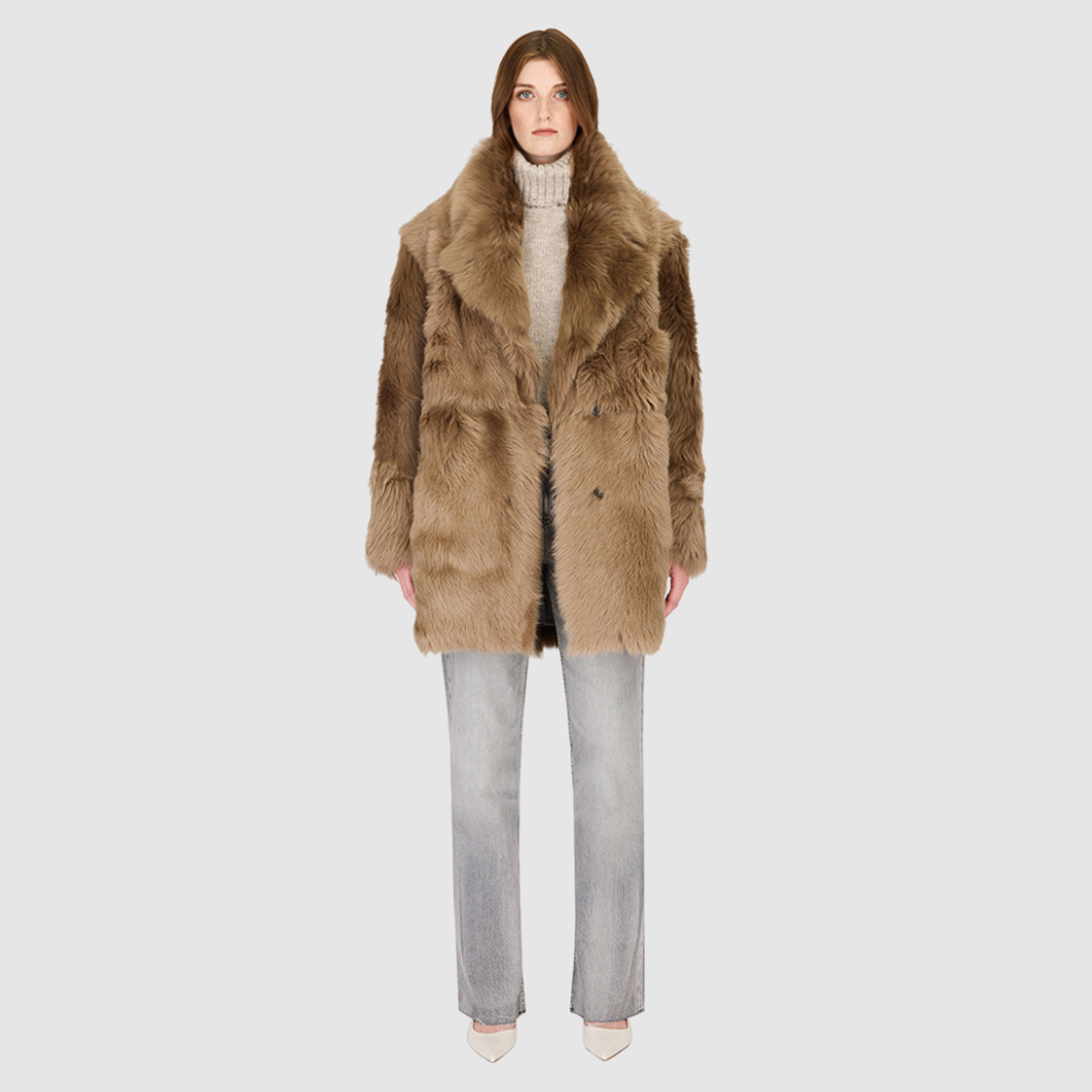 The SEER Jacket is a luxurious oversized outerwear piece crafted in Latte Toscana wool-out teddy. Designed with a structured shoulder and oversized Toscana notch collar, it delivers a bold, elevated silhouette. Fully lined for comfort, the jacket features slash side pockets for functionality and a single-breasted button closure for a polished finish. SEER combines plush texture with timeless tailoring for a standout cold-weather essential.