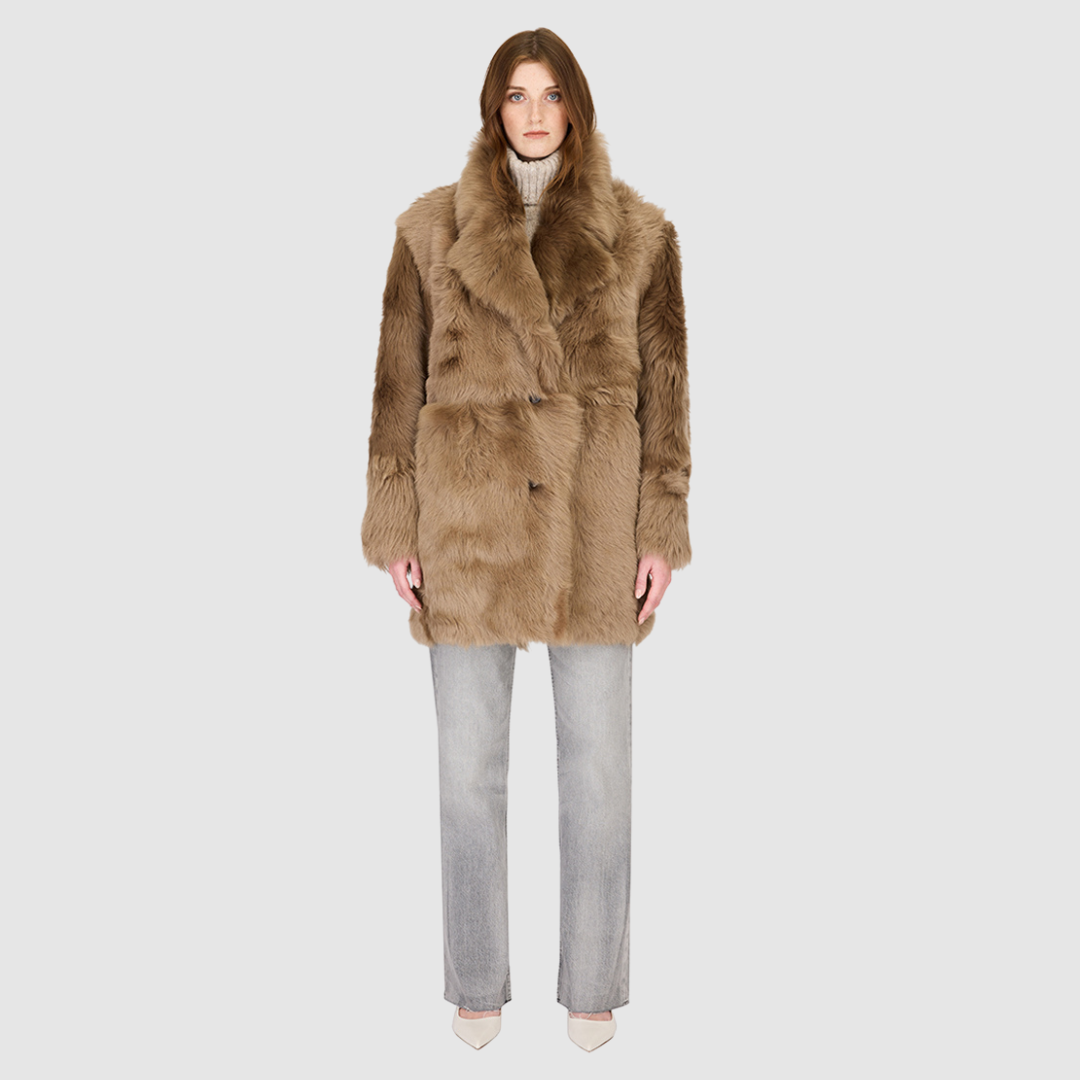 The SEER Jacket is a luxurious oversized outerwear piece crafted in Latte Toscana wool-out teddy. Designed with a structured shoulder and oversized Toscana notch collar, it delivers a bold, elevated silhouette. Fully lined for comfort, the jacket features slash side pockets for functionality and a single-breasted button closure for a polished finish. SEER combines plush texture with timeless tailoring for a standout cold-weather essential.