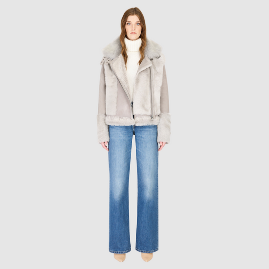 The SOUL Jacket is a heritage-inspired shearling moto crafted in suede and toscana rasado wool for a bold, modern edge. Its soft wool on a sleek suede body, drop shoulder, and sheared wool sleeves create a striking contrast of texture and silhouette. The Toscana long wool collar with double buckle detail, asymmetrical front zip closure, and functional side and interior zip pockets make SOUL both stylish and practical. Perfect for après-ski layering or elevated citywear.