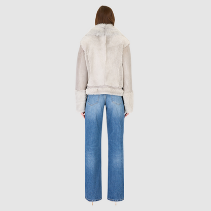 The SOUL Jacket is a heritage-inspired shearling moto crafted in suede and toscana rasado wool for a bold, modern edge. Its soft wool on a sleek suede body, drop shoulder, and sheared wool sleeves create a striking contrast of texture and silhouette. The Toscana long wool collar with double buckle detail, asymmetrical front zip closure, and functional side and interior zip pockets make SOUL both stylish and practical. Perfect for après-ski layering or elevated citywear.
