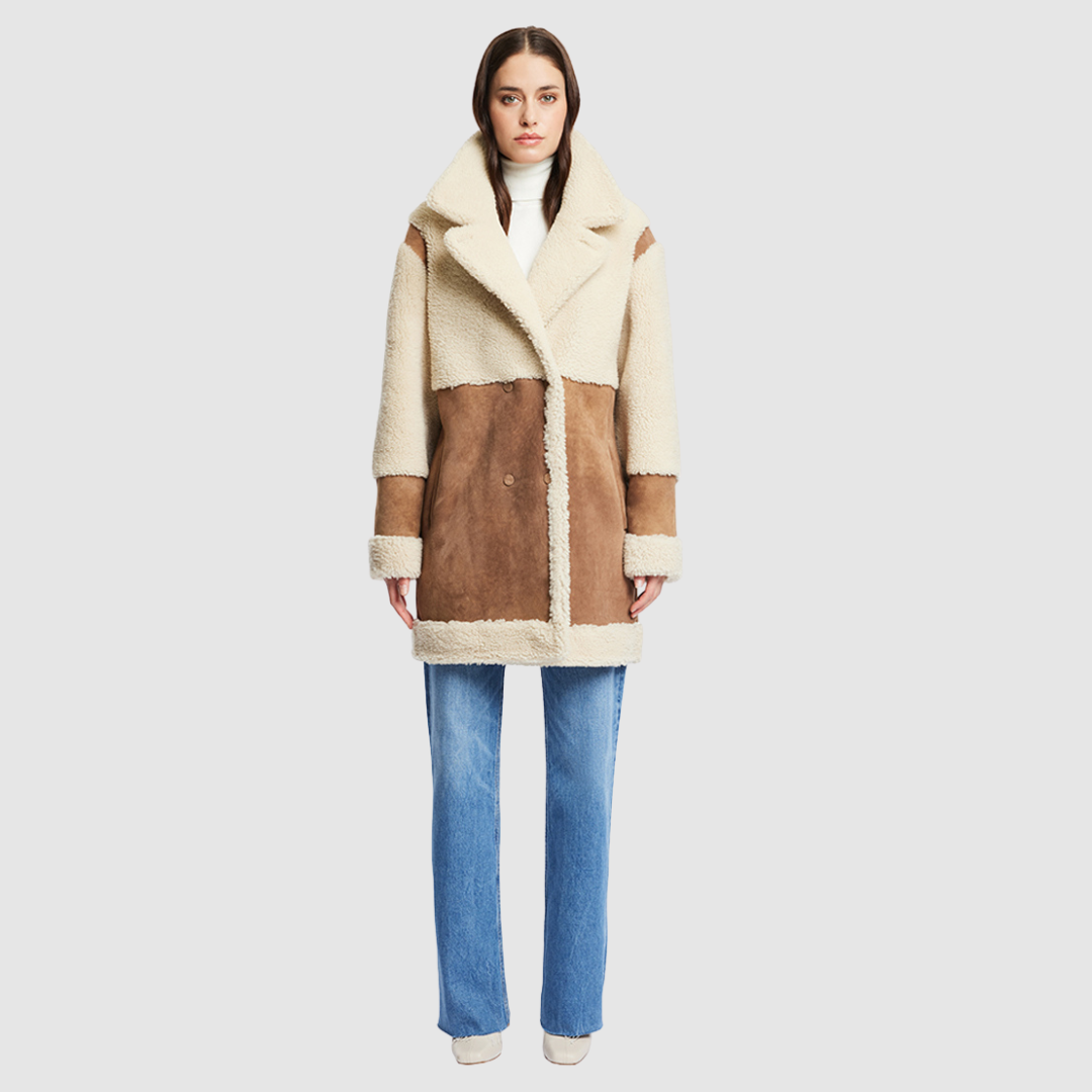 The URBAN Reversible Shearling Jacket fuses contemporary design with timeless shearling craftsmanship. Cut in an oversized silhouette with relaxed shoulders, deep armholes, and wide sleeves, it offers effortless comfort with a modern edge. Crafted from sleek cashew suede and plush beige curly wool, its fully reversible construction allows for versatile styling. With its straight fit and clean snap closure, URBAN is a bold statement piece ideal for both heritage looks and après-ski layering.