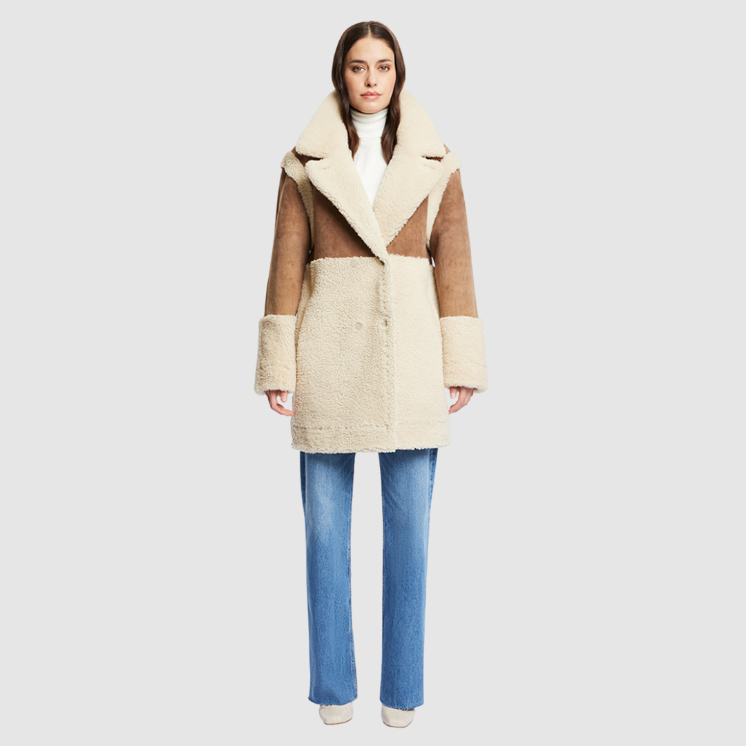 The URBAN Reversible Shearling Jacket fuses contemporary design with timeless shearling craftsmanship. Cut in an oversized silhouette with relaxed shoulders, deep armholes, and wide sleeves, it offers effortless comfort with a modern edge. Crafted from sleek cashew suede and plush beige curly wool, its fully reversible construction allows for versatile styling. With its straight fit and clean snap closure, URBAN is a bold statement piece ideal for both heritage looks and après-ski layering.