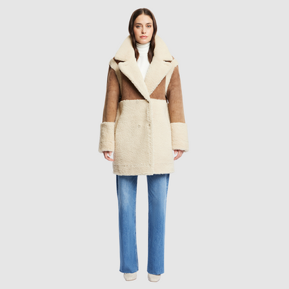 The URBAN Reversible Shearling Jacket fuses contemporary design with timeless shearling craftsmanship. Cut in an oversized silhouette with relaxed shoulders, deep armholes, and wide sleeves, it offers effortless comfort with a modern edge. Crafted from sleek cashew suede and plush beige curly wool, its fully reversible construction allows for versatile styling. With its straight fit and clean snap closure, URBAN is a bold statement piece ideal for both heritage looks and après-ski layering.