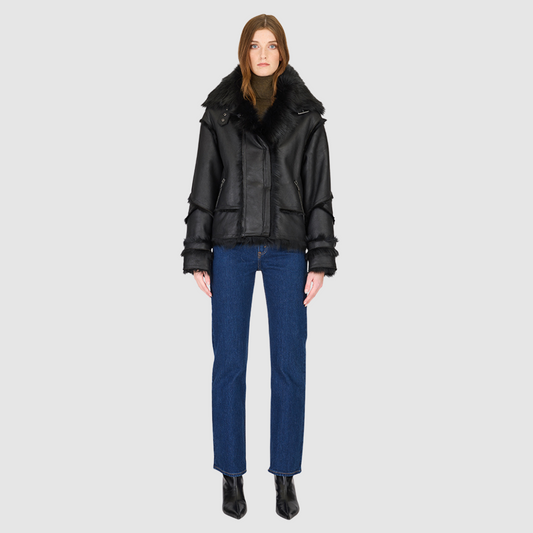 The VENUS Moto Shearling Jacket is a modern interpretation of the classic moto, crafted in supple nappa leather with Toscana wool-out seam detailing. Its drop-shoulder silhouette adds effortless ease, while the spread Toscana collar with buckle detail delivers a bold, statement finish. Designed for both form and function, VENUS features interior and exterior zip pockets to secure essentials. A front snap closure completes this sleek, cold-weather essential with understated edge.