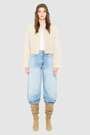 The HiSO SORA Jacket is a heritage-inspired cropped shearling jacket, masterfully crafted from premium curly wool shearling for rich texture and dimension. Its regular shoulder and tailored cropped silhouette create a sleek, contemporary fit, while the collarless design and clean edges offer a minimalist, modern aesthetic. Fully lined for exceptional comfort and designed with a hidden hook closure for a seamless finish, the jacket features standard straight sleeves and functional slash side pockets