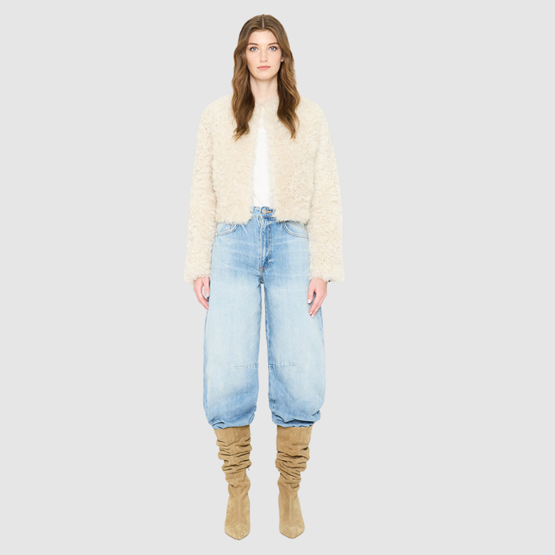 The HiSO SORA Jacket is a heritage-inspired cropped shearling jacket, masterfully crafted from premium curly wool shearling for rich texture and dimension. Its regular shoulder and tailored cropped silhouette create a sleek, contemporary fit, while the collarless design and clean edges offer a minimalist, modern aesthetic. Fully lined for exceptional comfort and designed with a hidden hook closure for a seamless finish, the jacket features standard straight sleeves and functional slash side pockets