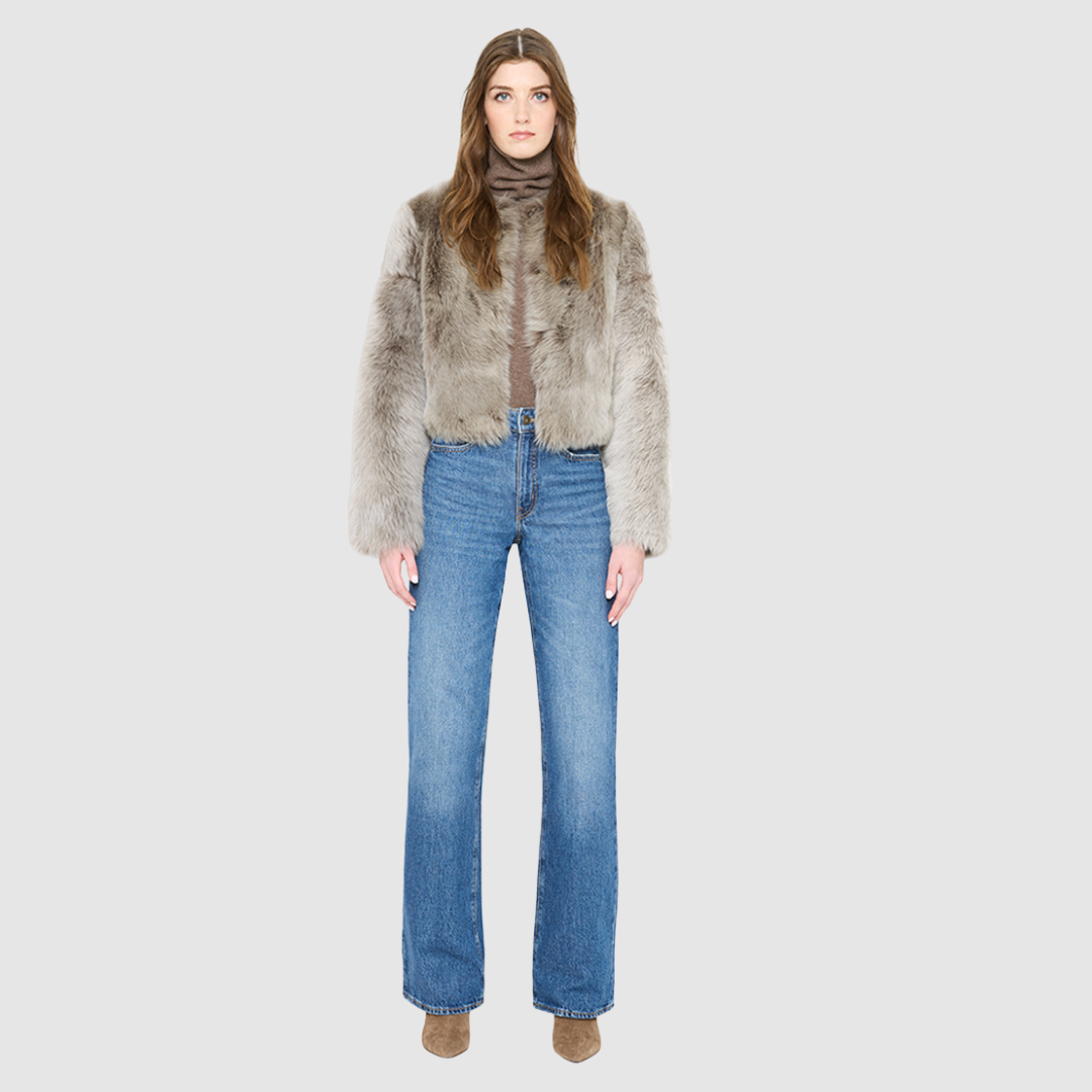 The SORA redefines urban luxury with an understated, sophisticated aesthetic tailored for the discerning eye. This exceptional statement piece features a plush toscana wool shearling that introduces a tactile dimension to cold-weather dressing. Fully lined for comfort, it provides an ultra-soft layer that glides on effortlessly while maintaining a structured, refined drape. Its clean collarless cropped silhouette flatters the form, shifting gracefully from casual street style to high-end evening wear. 