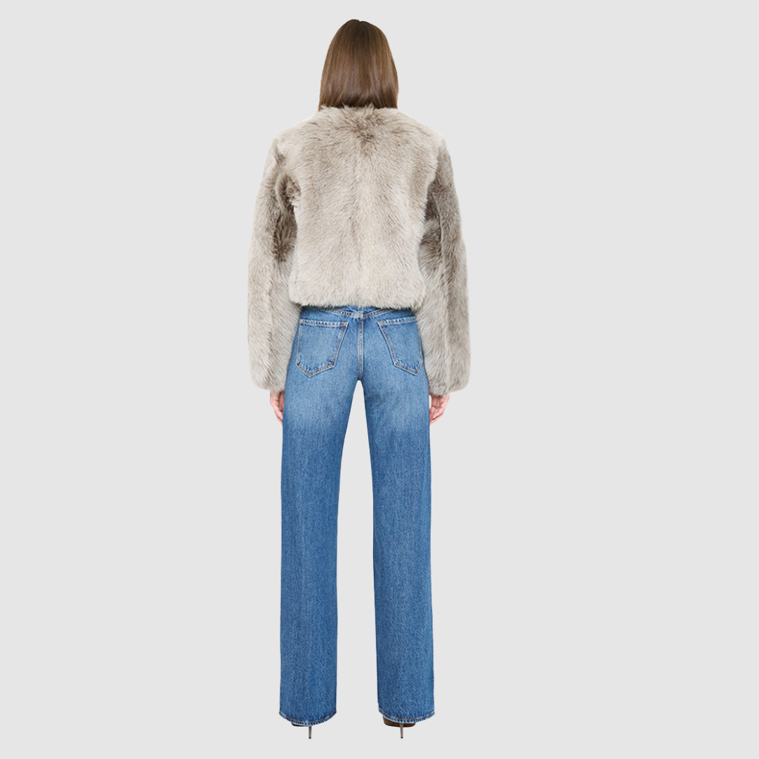The SORA redefines urban luxury with an understated, sophisticated aesthetic tailored for the discerning eye. This exceptional statement piece features a plush toscana wool shearling that introduces a tactile dimension to cold-weather dressing. Fully lined for comfort, it provides an ultra-soft layer that glides on effortlessly while maintaining a structured, refined drape. Its clean collarless cropped silhouette flatters the form, shifting gracefully from casual street style to high-end evening wear. 