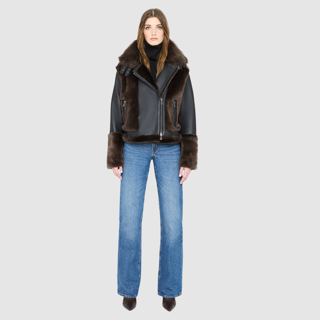 The SOUL Moto Shearling Coat brings together sleek nappa leather and plush shearling in a bold, urban-luxury design. Its drop-shoulder silhouette and sheared wool body create a modern fit, while the wool-out cuffs and toscana long wool collar with double buckle detail add dramatic texture. An asymmetrical front zip closure enhances its moto edge, balanced by functional side and interior zip pockets. Designed to be both striking and functional, SOUL is a contemporary classic for cold-weather styling.