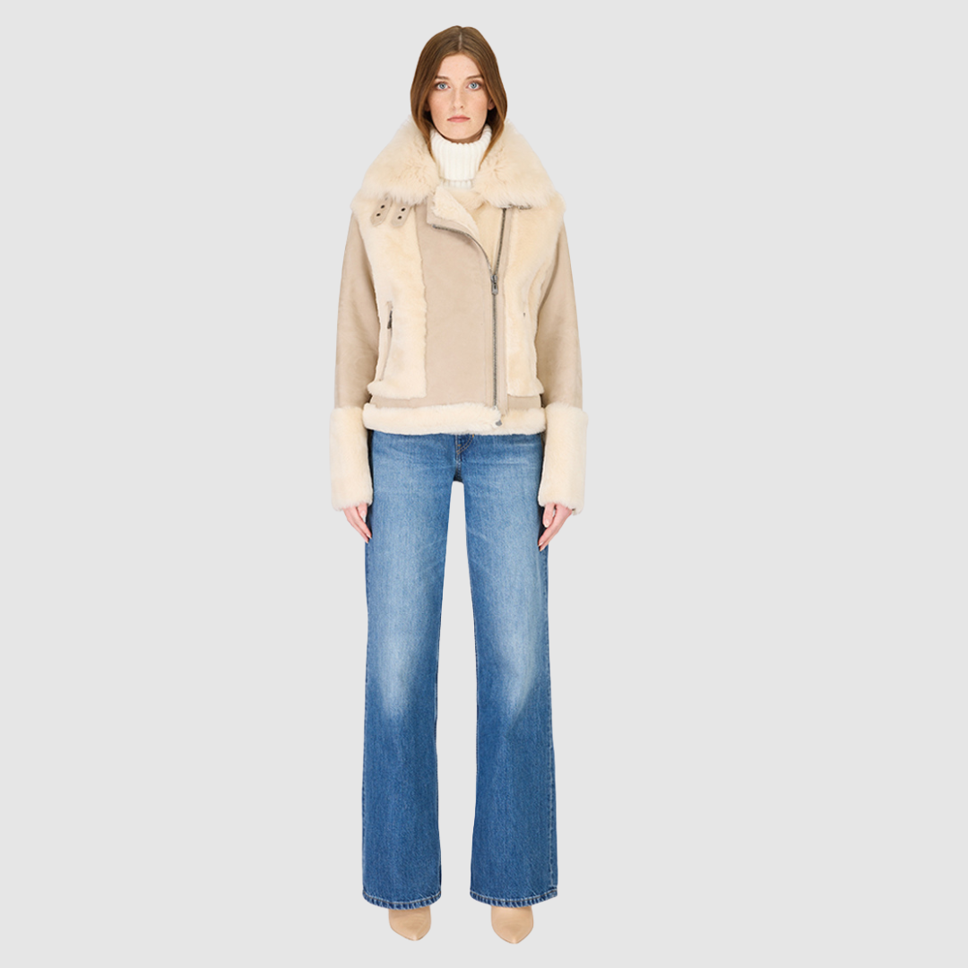 The SOUL Moto Shearling Coat brings together sleek suede leather and plush shearling in a bold, urban-luxury design. Its drop-shoulder silhouette and sheared wool body create a modern fit, while the wool-out cuffs and toscana long wool collar with double buckle detail add dramatic texture. An asymmetrical front zip closure enhances its moto edge, balanced by functional side and interior zip pockets. Designed to be both striking and functional, SOUL is a contemporary classic for cold-weather styling.