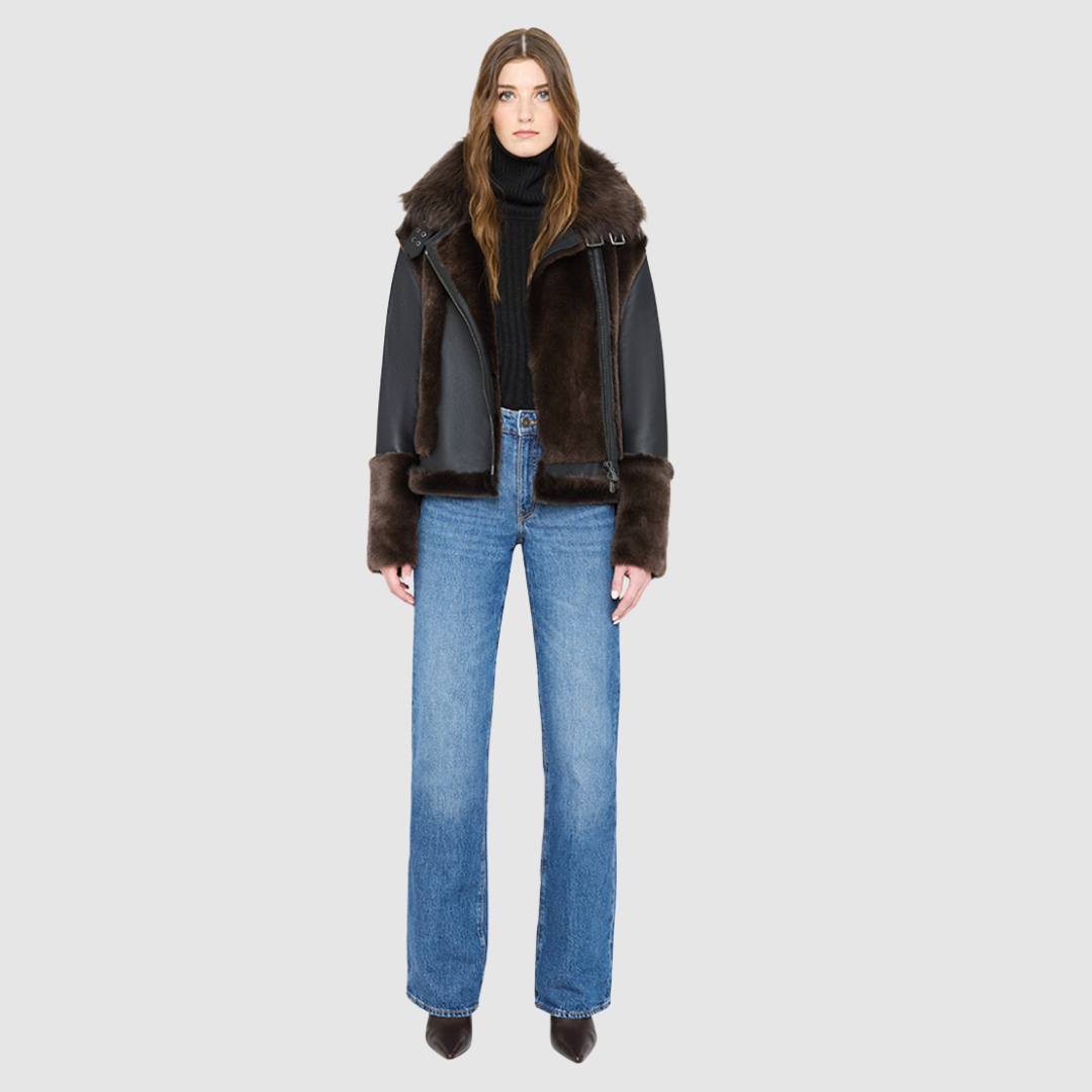 The SOUL Moto Shearling Coat brings together sleek nappa leather and plush shearling in a bold, urban-luxury design. Its drop-shoulder silhouette and sheared wool body create a modern fit, while the wool-out cuffs and toscana long wool collar with double buckle detail add dramatic texture. An asymmetrical front zip closure enhances its moto edge, balanced by functional side and interior zip pockets. Designed to be both striking and functional, SOUL is a contemporary classic for cold-weather styling.