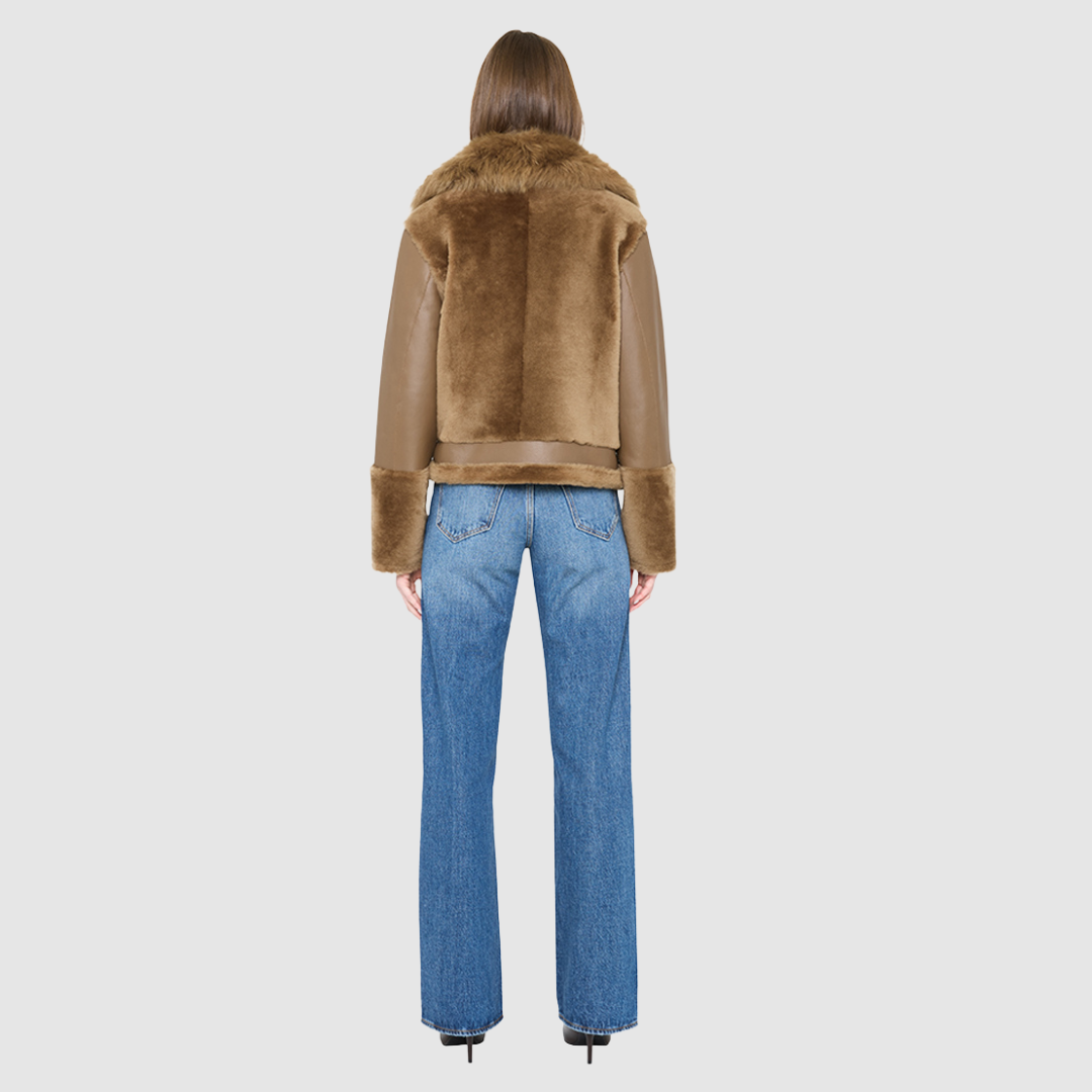 The SOUL Moto Shearling Coat brings together sleek nappa leather and plush shearling in a bold, urban-luxury design. Its drop-shoulder silhouette and sheared wool body create a modern fit, while the wool-out cuffs and toscana long wool collar with double buckle detail add dramatic texture. An asymmetrical front zip closure enhances its moto edge, balanced by functional side and interior zip pockets. Designed to be both striking and functional, SOUL is a contemporary classic for cold-weather styling.