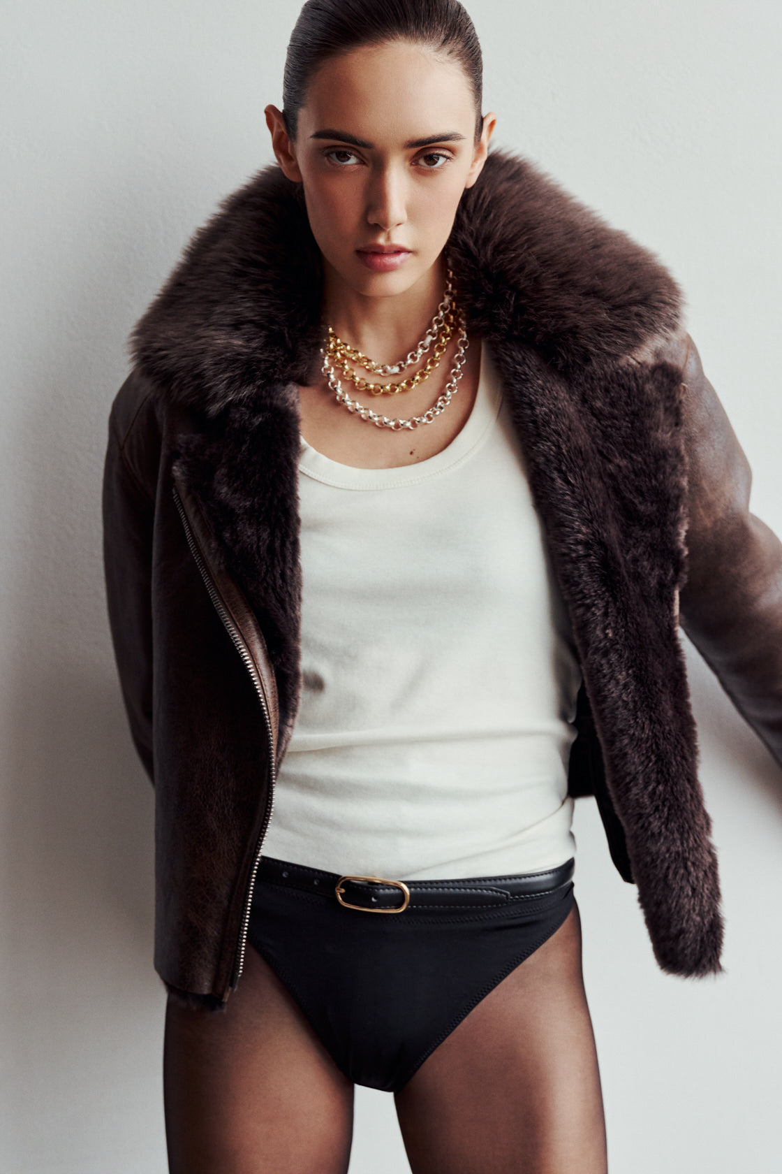 VRILL redefines alpine chic with a sharp, asymmetric profile tailored for effortless seasonal transitions. This cold-weather staple frames the body beautifully, pairing a refined matte nappa leather exterior with a uniform, plush ironed wool interior. Engineered for ultimate versatility across changing climates, the design transitions seamlessly from a classic skin-out moto jacket to a texture-forward statement piece complete with an exaggerated collar.