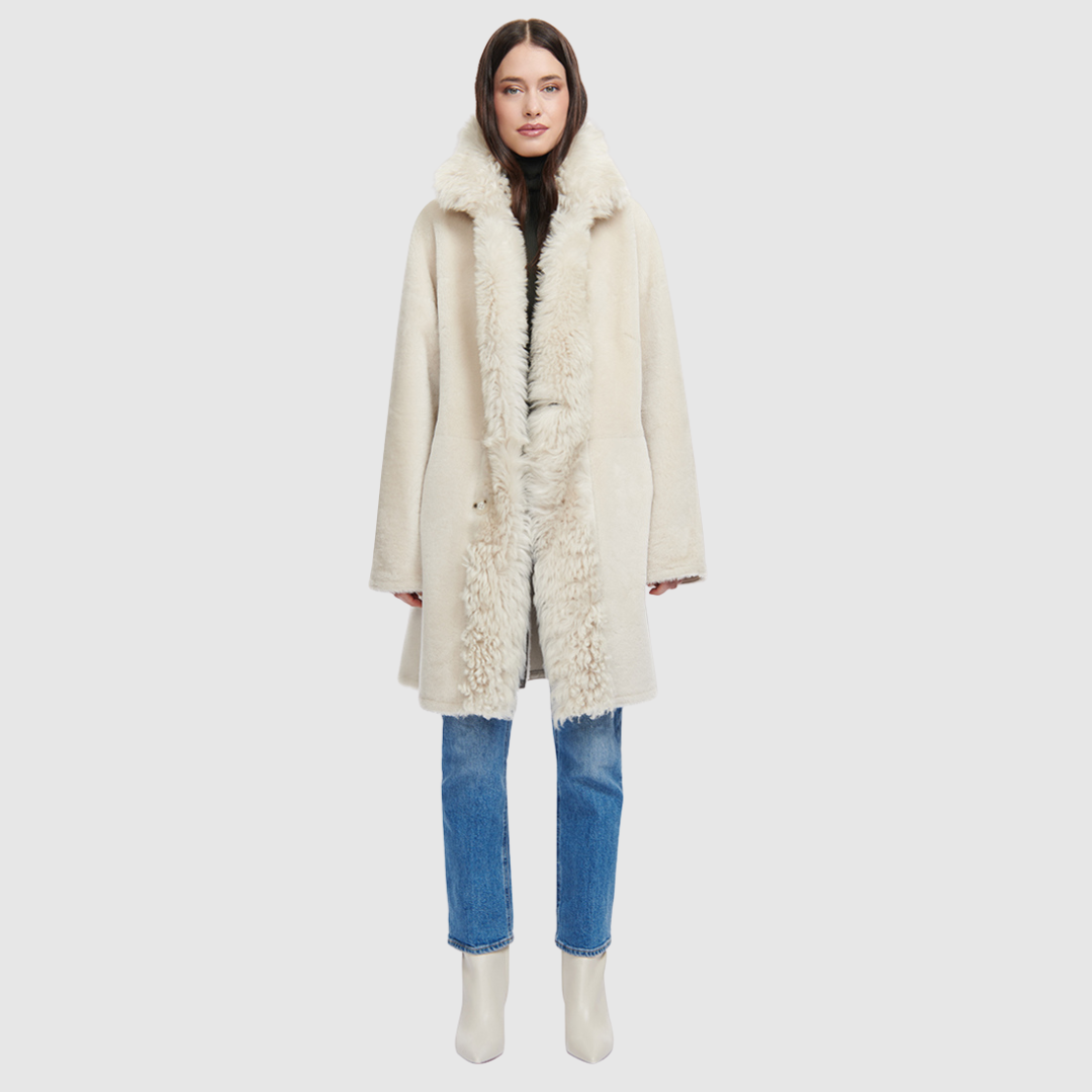 The August Ivory Reversible Shearling Jacket is a versatile outerwear staple that blends refined tailoring with modern ease. Crafted in supple nappa leather, it reverses to an ironed wool teddy for a completely different look and feel. Designed with a slightly dropped shoulder and a loose, relaxed silhouette, it’s finished with a double-breasted button closure for a polished yet effortless finish.
