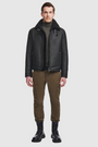 The Code Black Shearling Moto is a bold reinterpretation of a classic moto jacket, merging sleek nappa leather with plush curly wool shearling. Designed for a true-to-size fit, it features a spread collar with a buckle detail for added edge, a standard front zip closure, and an interior zip pocket for functionality. This piece balances rugged refinement with modern versatility, making it a cold-weather essential.