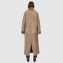 The DANIELLE Duster is a statement in heritage-inspired luxury and modern versatility. Crafted in taupe iron wool and plush iron wool shearling, this reversible oversized coat transitions effortlessly from sleek suede to cozy teddy texture. Its elongated silhouette is enhanced with a slight drop shoulder, back vent, and double-breasted button closure, creating timeless elegance with functional edge. Practical single welt pockets on the suede side and slash pockets on the wool side make DANIELLE a refined ch